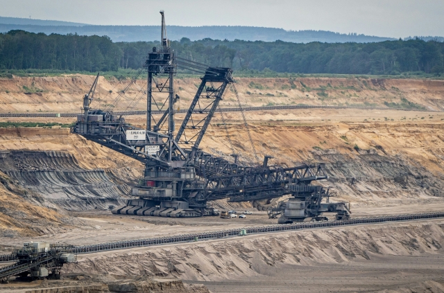 A coal mine nestled in the mountains, extracting valuable resources from the earth's depths.